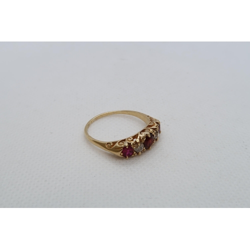 69 - An 18ct yellow gold (hallmarked) five stone bridge ring with ruby, diamond and red garnet - ring siz... 