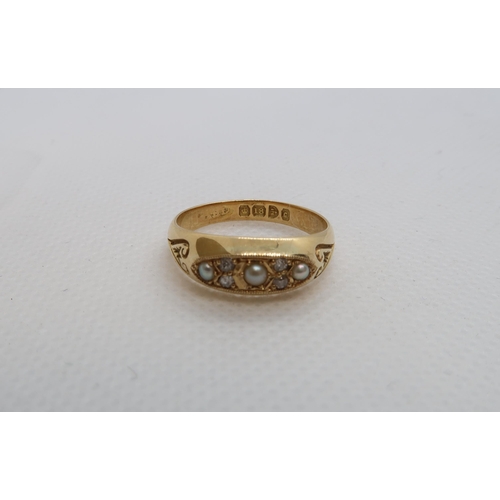 72 - An 18ct (hallmarked) yellow gold ring with pearls and diamond accent - ring size N/O - weight approx... 