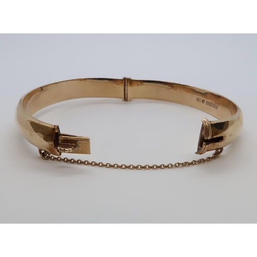 80 - A 9ct yellow gold (hallmarked) hinged bangle - Diameter 6.5cm - weight approx 12.7 grams - good over... 