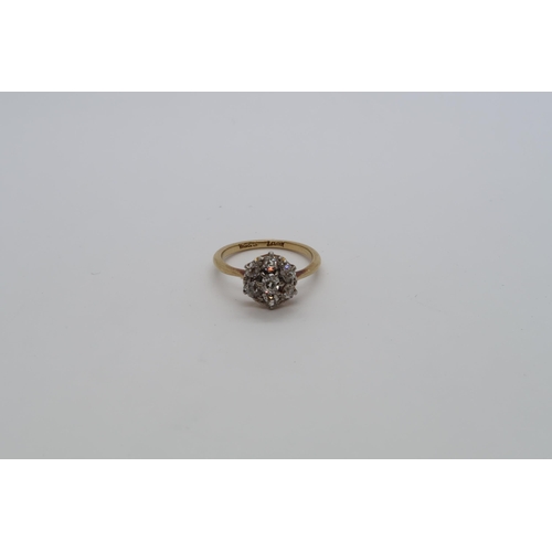 83 - An 18ct yellow gold (hallmarked) diamond daisy cluster ring set with old mine cut diamonds, size K, ... 