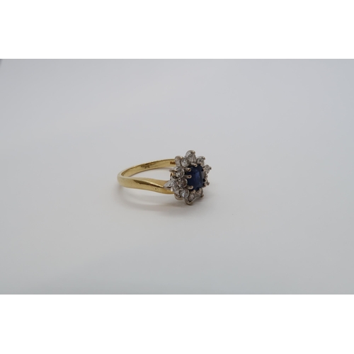 93 - An 18ct yellow gold hallmarked sapphire and diamond cluster ring, size N/O, approx 5.3 grams