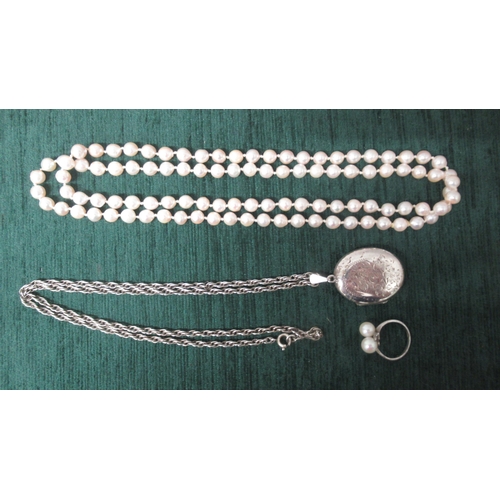 203 - A silver locket on chain together with a silver and pearl ring and a string of pearls