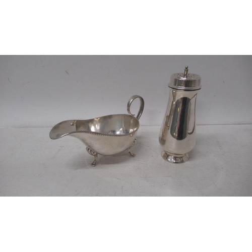 281 - A silver sugar sifter, Garrard & Co Birmingham 1963 - 15cm - together with silver sauce boat - Sheff... 