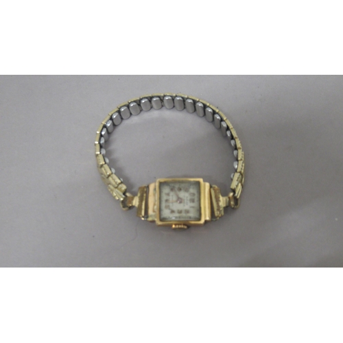 319A - A ladies 18ct (hallmarked) yellow gold cased Reflux wristwatch on plated strap - not working