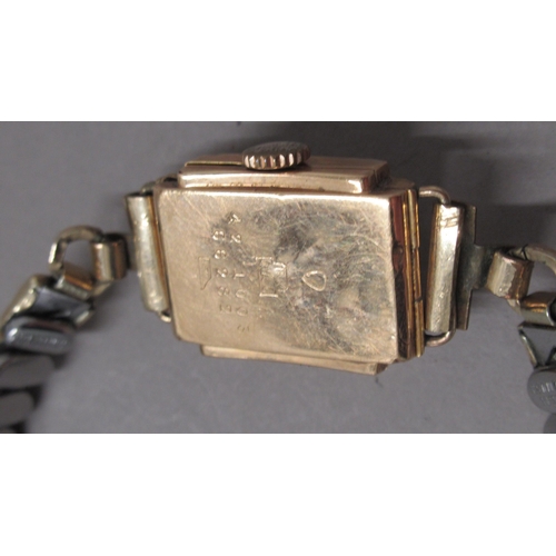 319A - A ladies 18ct (hallmarked) yellow gold cased Reflux wristwatch on plated strap - not working