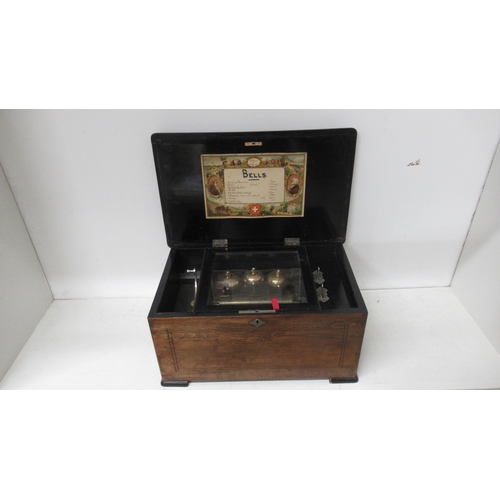 403A - A 19th century rosewood and inlaid music box playing 8 airs on three bells, in working order - teeth... 