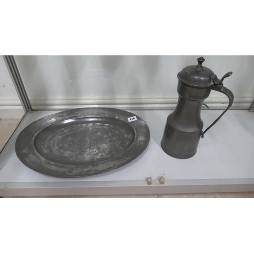 418 - An 18th century Pewter charger - 43cm x 30cm - and a pewter jug