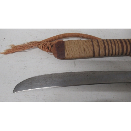 454 - A Burmese DHA sword wooden handle with copper hilt and rope bound wood scabbard, curved steal blade,... 