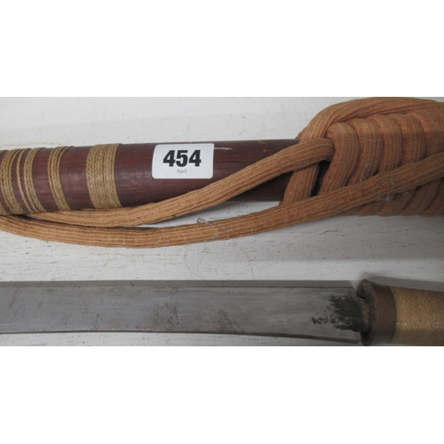 454 - A Burmese DHA sword wooden handle with copper hilt and rope bound wood scabbard, curved steal blade,... 