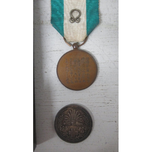 457 - A Japanese Order of the Rising Sun Medal in Lacquer box together with a Japanese Red Cross silver co... 