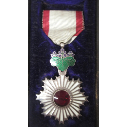 457 - A Japanese Order of the Rising Sun Medal in Lacquer box together with a Japanese Red Cross silver co... 