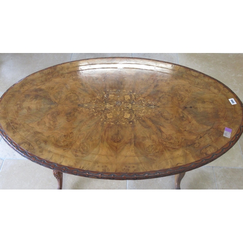 594 - A 19th century walnut and marquetry oval centre table on turned and carved legs and a cross stretche... 