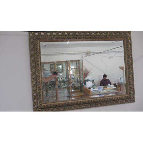 624 - A modern carved pine mirror with bevelled glass - 112cm x 81cm