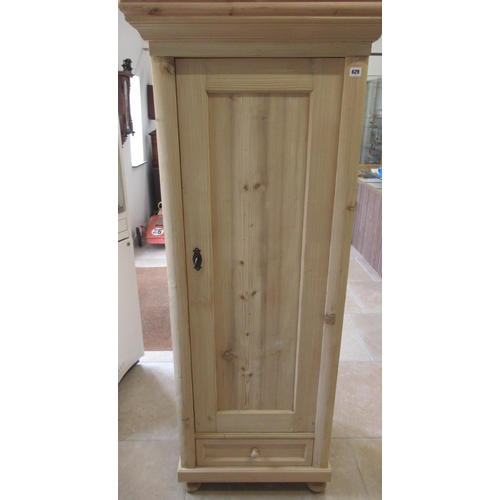 629 - A stripped pine cabinet with shelves and bottom drawer, lock and key - 174cm x 70cm x 52cm