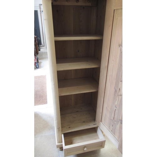 629 - A stripped pine cabinet with shelves and bottom drawer, lock and key - 174cm x 70cm x 52cm