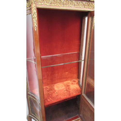 597 - A Continental mahogany and ormolu display cabinet with a single door, 140cm high x 68cm wide