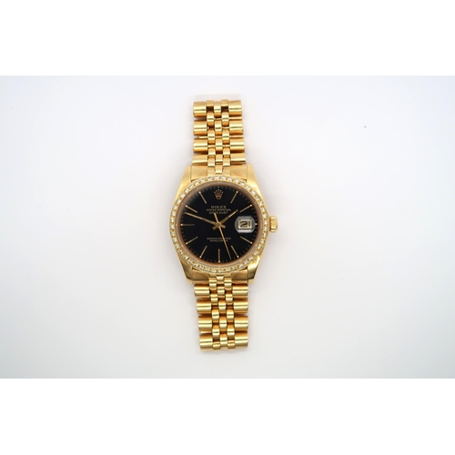A gents Rolex Datejust in 18ct yellow gold, black dial with diamond bezel, with Rolex 18ct yellow gold bracelet - good overall condition, with box and two spare links - case approx 35mm