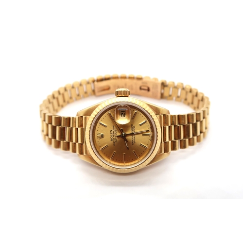 A ladies 18ct gold Rolex Oyster Perpetual Date Just - in good condition and full working order along with the original Garantie dated 21/04/1994 and a service card for 10/03/2017 for a service, the inner and outer boxes and all the other paperwork - consigned to the auction by the original owner