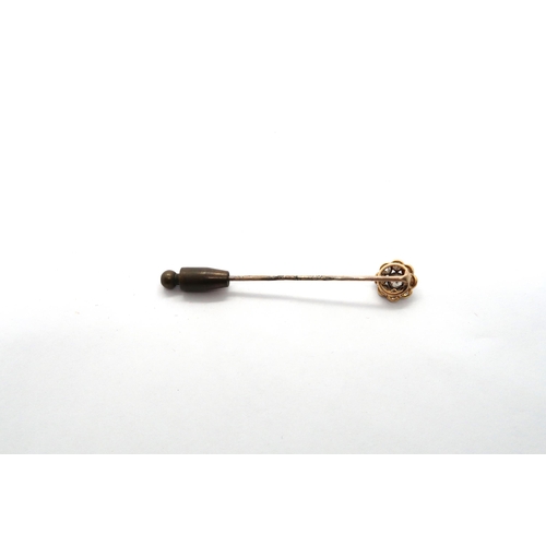 17 - A diamond daisy cluster tie pin - the central old cut diamond surrounded by eight smaller diamonds -... 