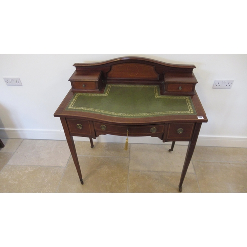 617 - An Edwardian mahogany and inlaid bow fronted ladies writing desk with a leather inset top over three... 