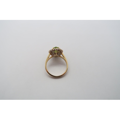 4 - An 18ct yellow gold marquis cut peridot and diamond ring, peridot is good colour, diamonds bright an... 