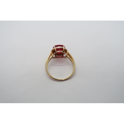 6 - A 9ct yellow gold ruby and diamond ring, head size 12mm diameter, ring size N/O