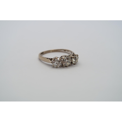 8 - A hallmarked 18ct white gold diamond three stone trilogy ring, central round cut diamond approx 0.6c... 