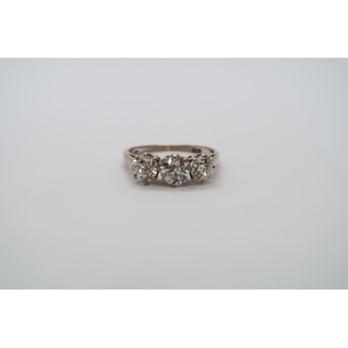 8 - A hallmarked 18ct white gold diamond three stone trilogy ring, central round cut diamond approx 0.6c... 