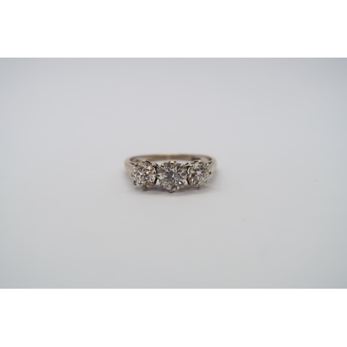 8 - A hallmarked 18ct white gold diamond three stone trilogy ring, central round cut diamond approx 0.6c... 