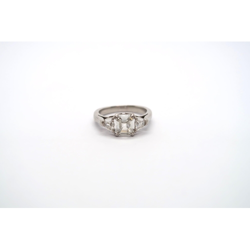 75 - A very good platinum three stone diamond ring - The square emerald cut diamond estimated 1.1ct, clar... 