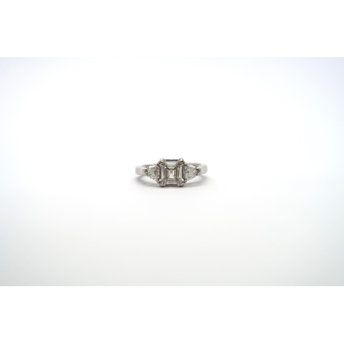 75 - A very good platinum three stone diamond ring - The square emerald cut diamond estimated 1.1ct, clar... 