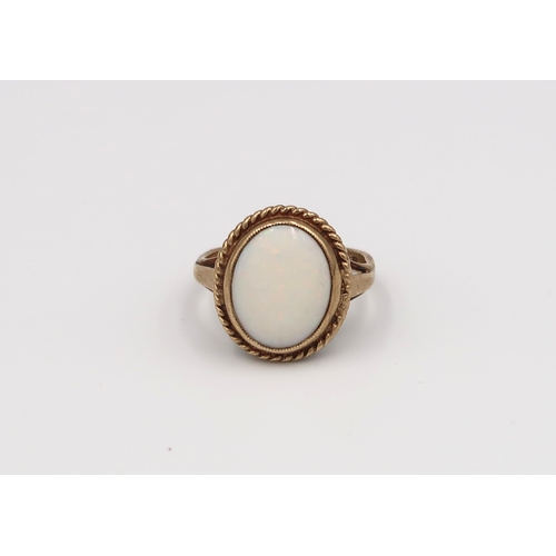 103 - A 9ct rolled gold circular pendant and ring, oval opal to shoulder - ring size H