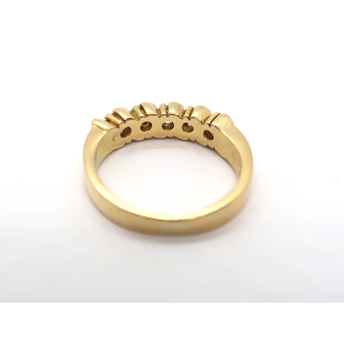 3 - A diamond eternity ring in yellow colour metal, part hoop, comprising of five round brilliant cut di... 