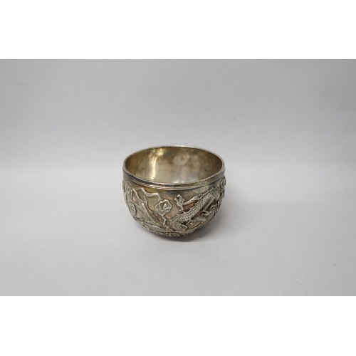 363 - A Chinese silver bowl marked 90 decorated with opposing dragons amongst foliage