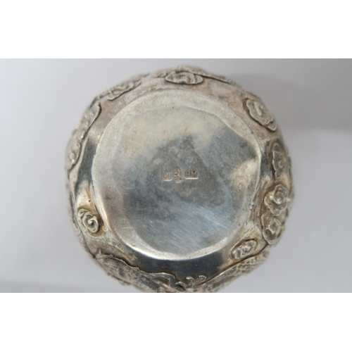 363 - A Chinese silver bowl marked 90 decorated with opposing dragons amongst foliage