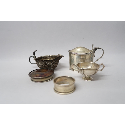 365 - A silver hallmarked mustard without liner, London, a small twin handled cup, Birmingham, a napkin ri... 