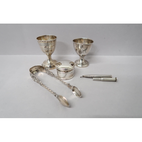 375 - Two silver Christening  egg cups, pill box and sugar nips along with a silver propelling pencil, Bir... 