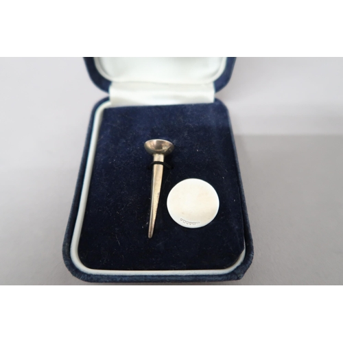 386 - A silver golf tee and ball marker, cased