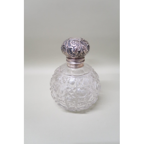 393 - A cut glass scent bottle with silver lid and glass stopper, overall height 13cm