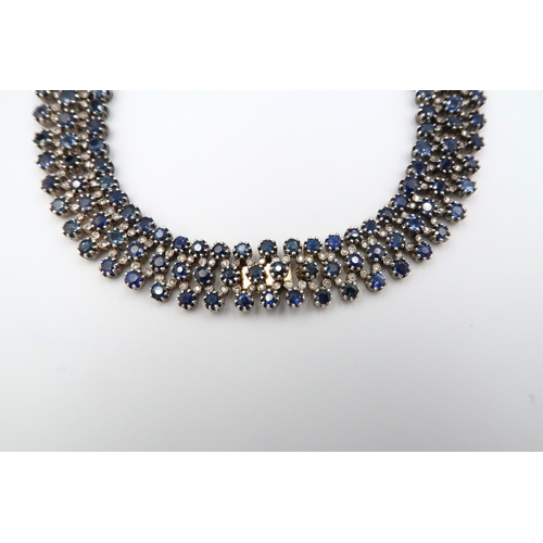 4 - A stunning three row articulated sapphire and diamond necklace. The graduating circular claw set sap... 