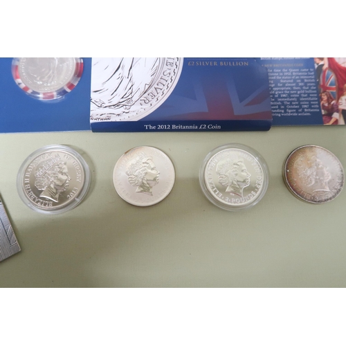 426 - Seven pure silver proof coins and a Britannia two pound sterling silver bullion coin and a ten pound... 