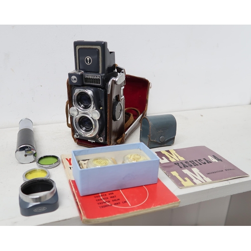 485 - A Yashica 44 camera and assorted lens, booklets etc