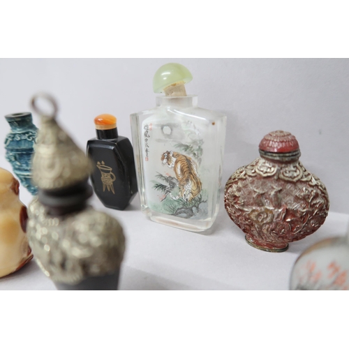 497 - Seven Oriental design perfume bottles, one glass decorated with a tiger amongst foliage with script ... 