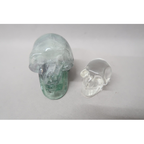 498 - A crystal skull 8cm deep x 7cm high x 6cm wide, and one smaller