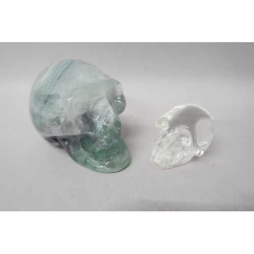 498 - A crystal skull 8cm deep x 7cm high x 6cm wide, and one smaller