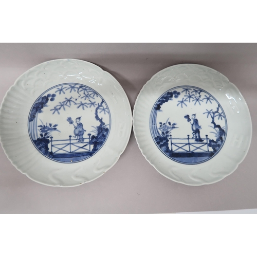 501 - Two Oriental blue and white plates decorated with figure on bridge with foliage to background, 21.5c... 