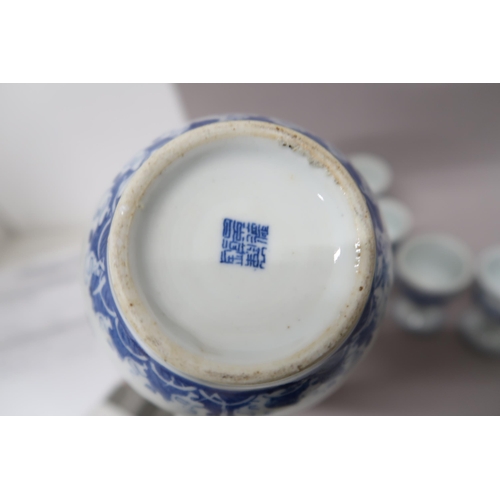 502 - An Oriental blue and white coffee pot decorated with opposing dragons above sea spray, eight blue an... 