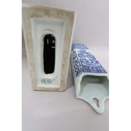 515 - A Japanese porcelain incense holder, 13cm x 14cm high x 6cm, and a blue and white wall pocket decora... 