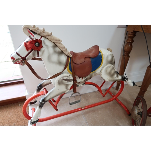 554 - A 20th Century Metal rocking horse on metal frame.