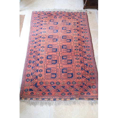 581 - A vintage Afghan rug, 195cm x 127cm